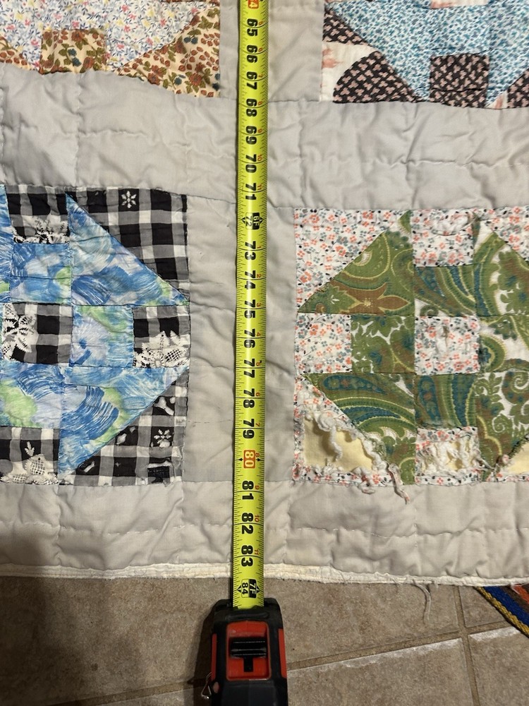 Cutters handmade scrappy patchwork quilt with varied fabric blocks.
