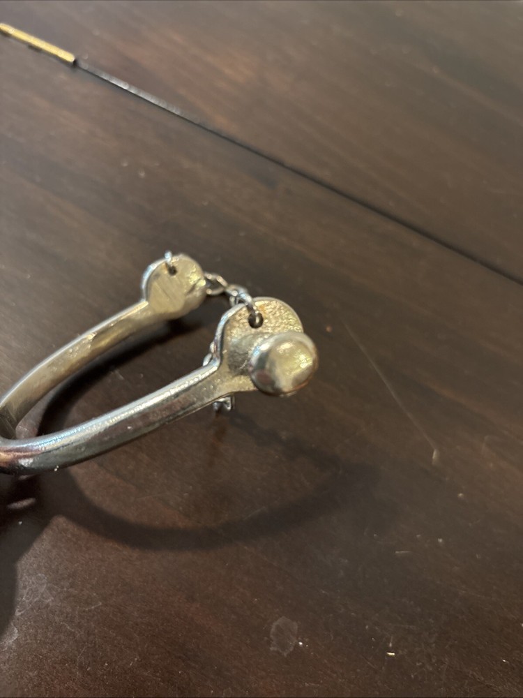 ONE UNMARKED SPUR - SILVER COLORED - SPINNING ROWEL
