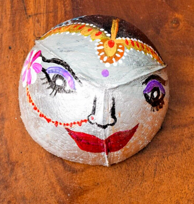 Coconut shells hand painted with different faces specified for hotel decorations
