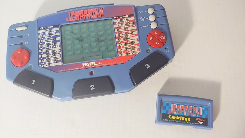 Jeopardy Handheld Electronic Game Complete with Answer/Question Book & Cartridge