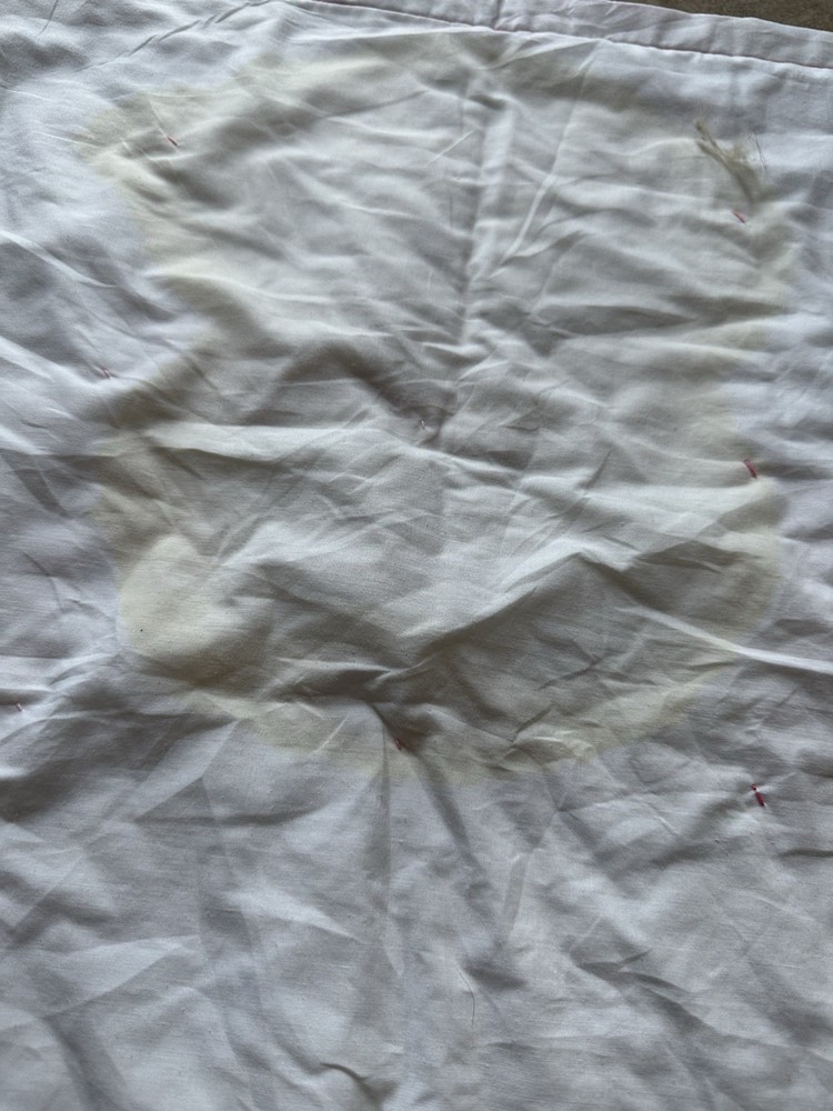 Handmade patchwork quilt with floral, plaid, and pink fabrics.