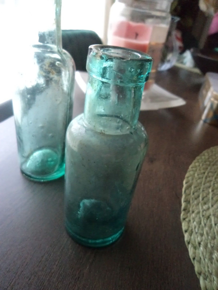 2 x antique aqua coloured bottles