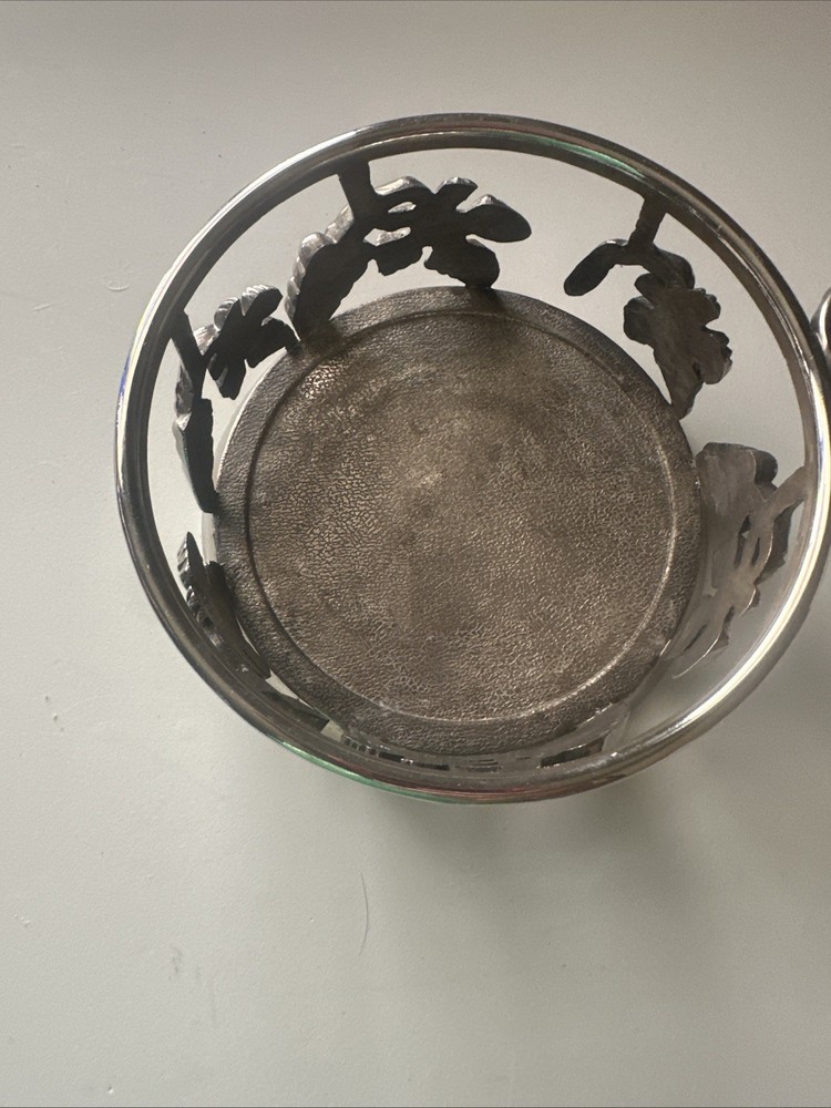 vintage, silver-plated wine bottle coaster featuring intricate grapevine pattern
