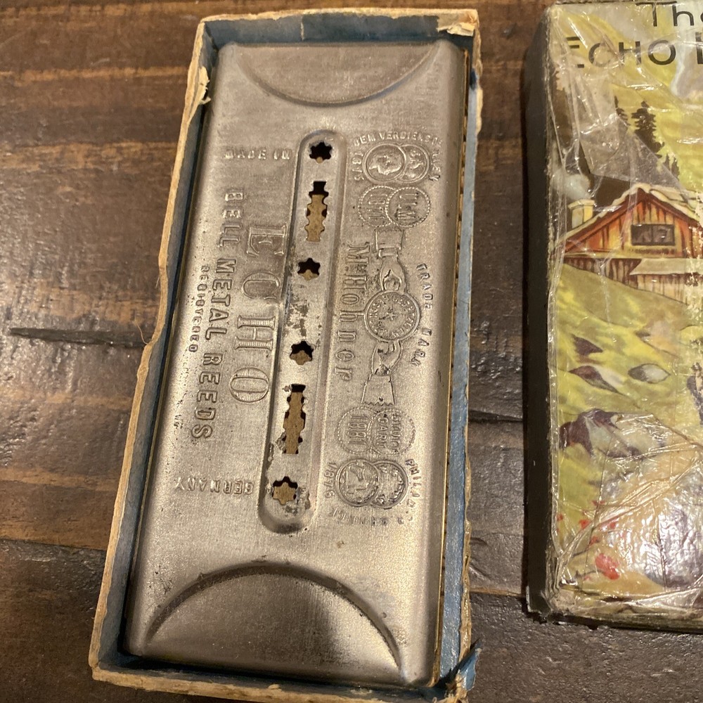 two M Hohner Echo harmonicas with rough boxes dofferent styles