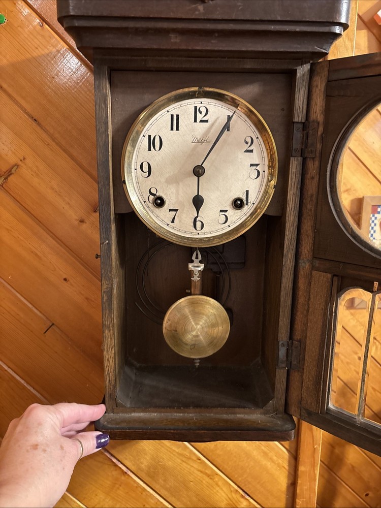 Vintage spring pendulum clock made by Meiji Clock Co.