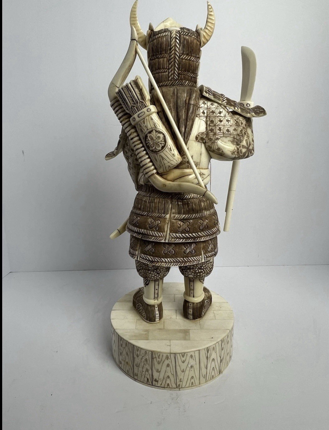 Japanese carved figure is a warrior.