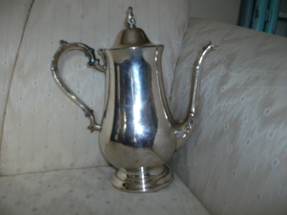 Silver coffee pot with insulated handle    round bottom