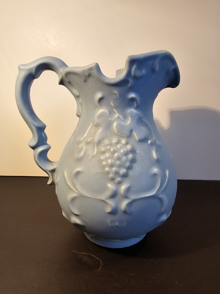 Blue Pitcher With Grapes And Leaves On The Side