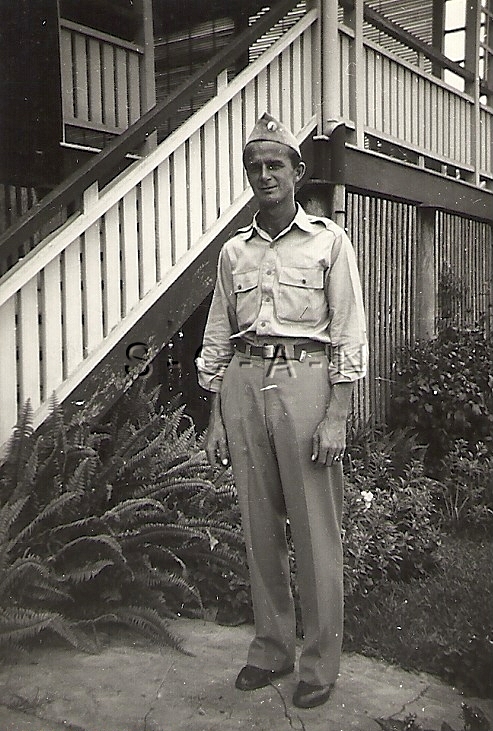 WWII Original Large Army RP- Soldier- Uniform- Hat- Stands by Bamboo Building