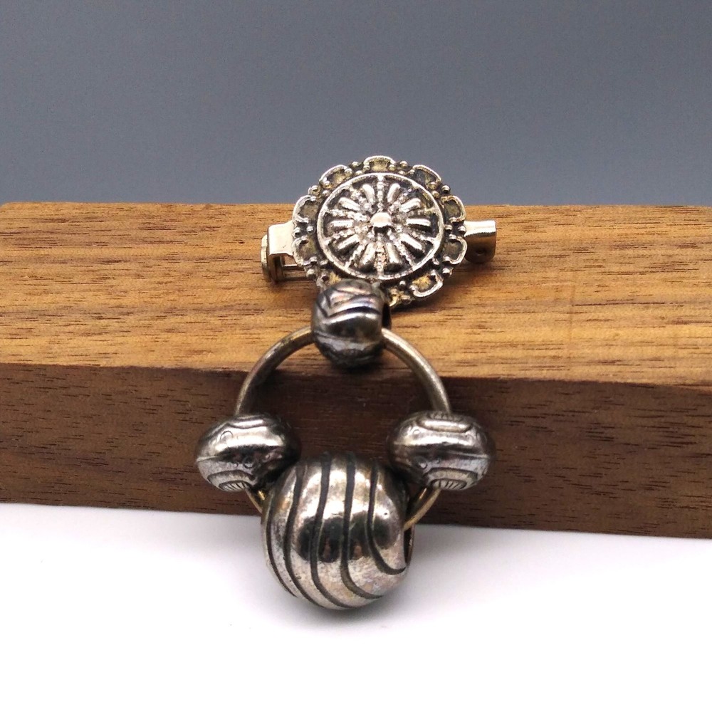 Silver Tone Dangle Brooch has a Tribal Flair with Repousse and Embossed Beads
