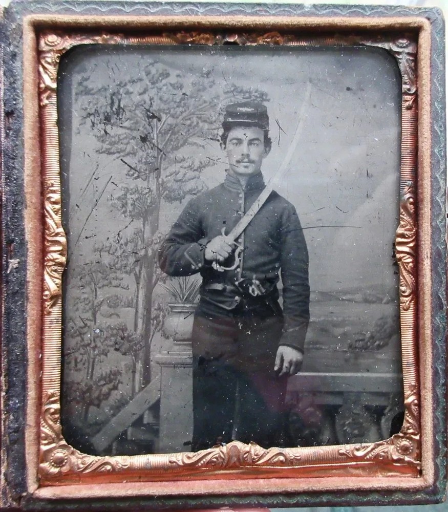 Civil War Ruby Ambrotype – Private Holding Eagle Head Saber & Colt Pocket