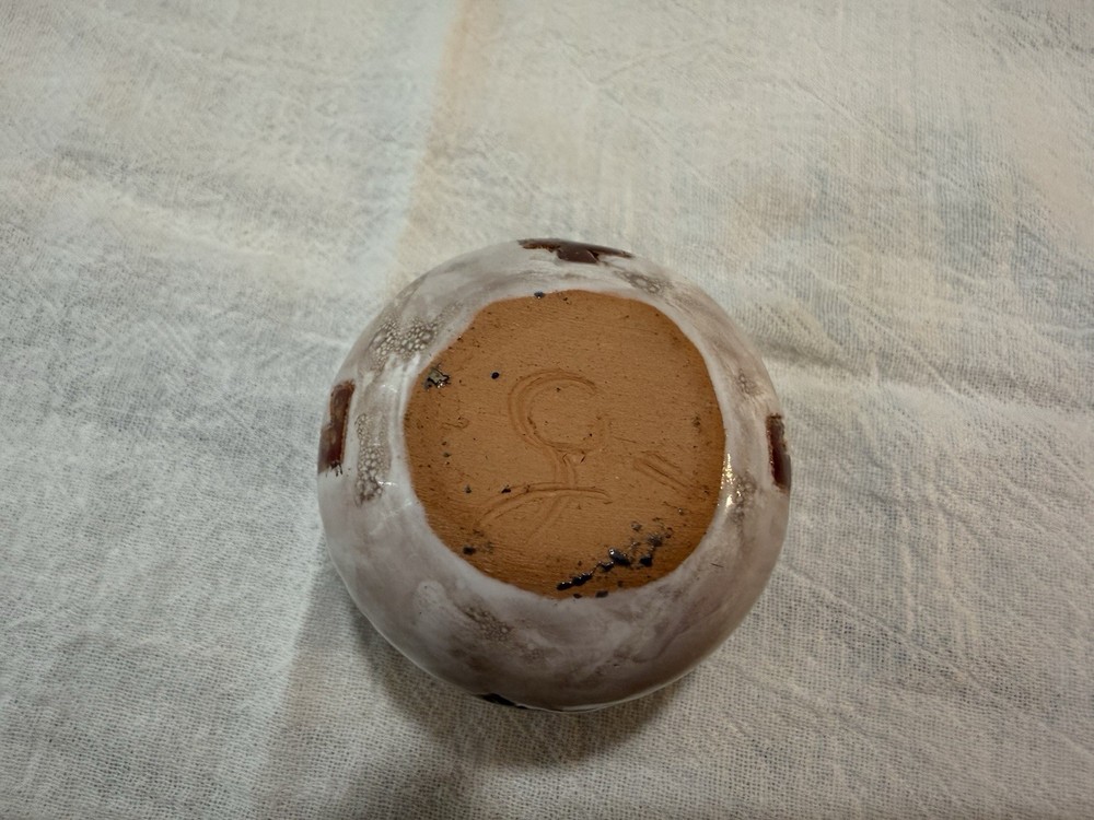 Handmade clay pottery with a distinct glazed finish.