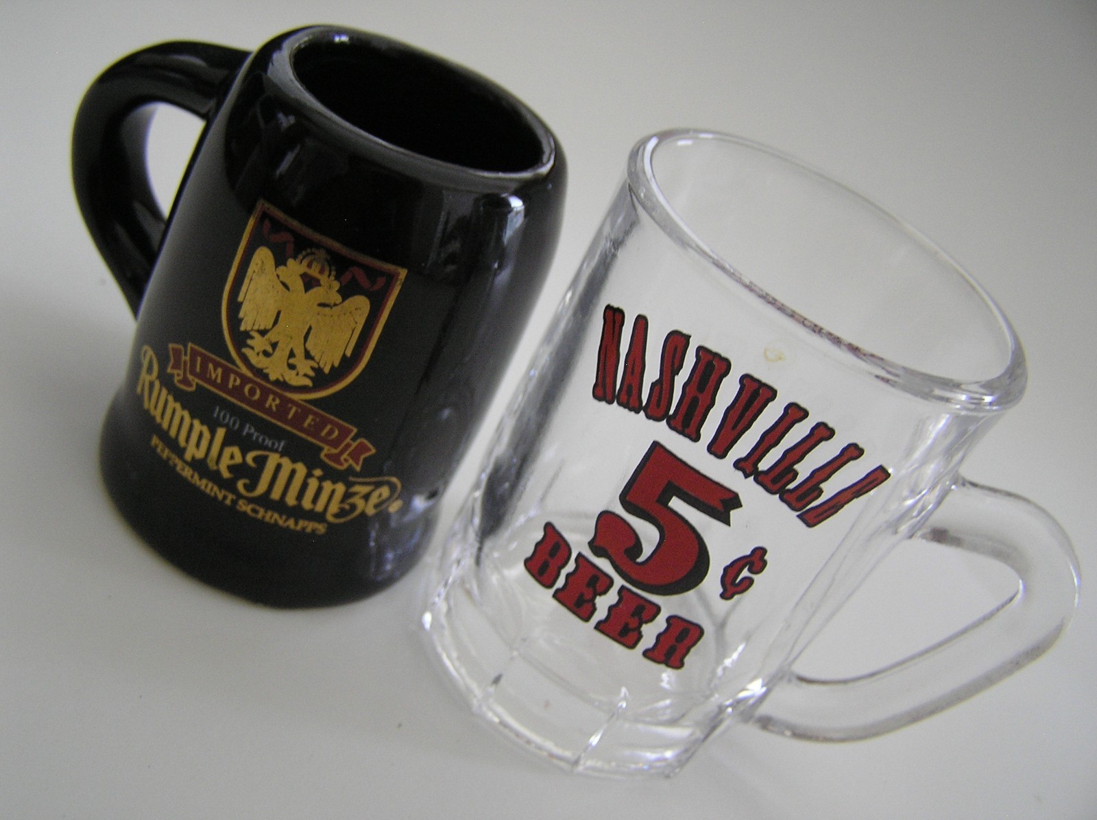 2 Souvenirs Shot Mugs: A Black Rumple Minze and A Clear Nashville 5cents Beer