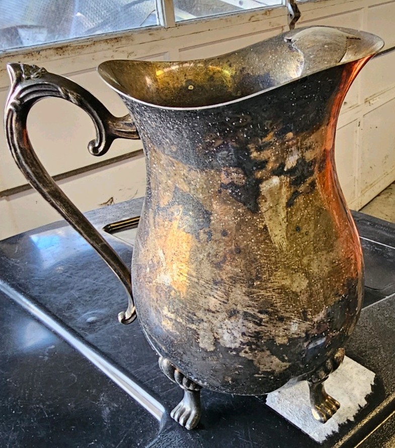 This vintage collectible is a silver-plated, footed pitcher
