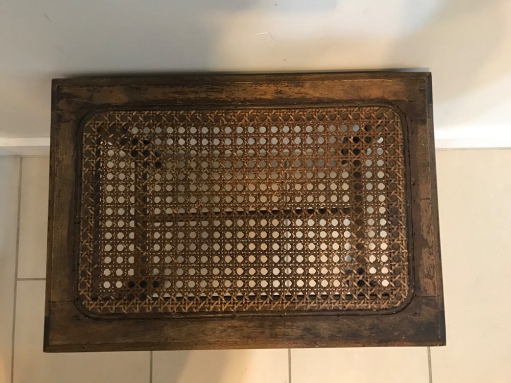 Caned-top footstool, ottoman or seat.