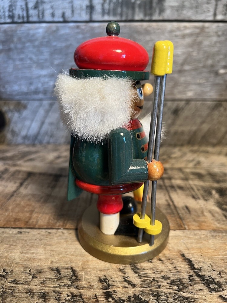 Vintage Christmas Nutcracker Holding Skies