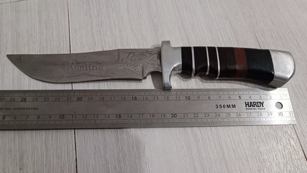 Antique handmade hunting knife with a pattern.