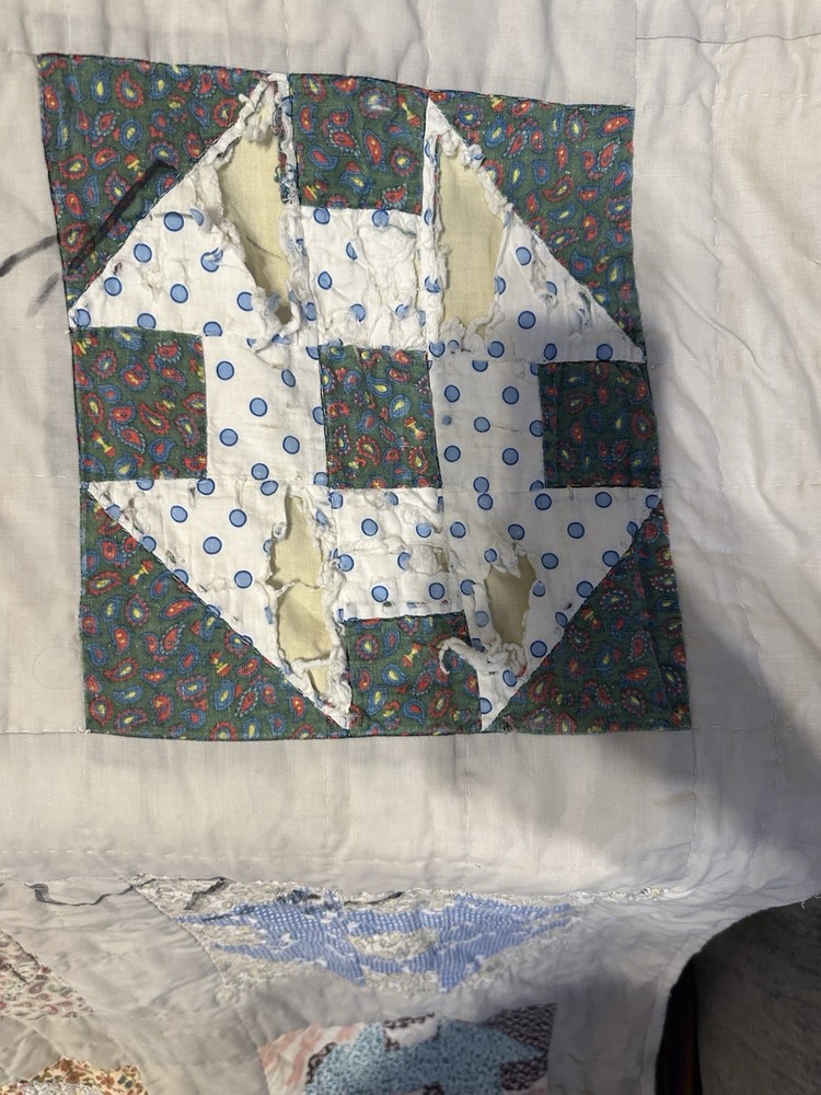 Cutters handmade scrappy patchwork quilt with varied fabric blocks.