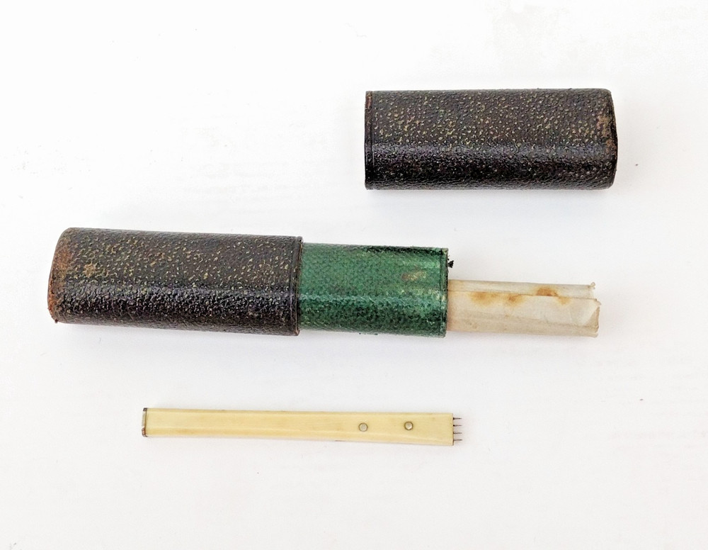 Brass microscope in case.