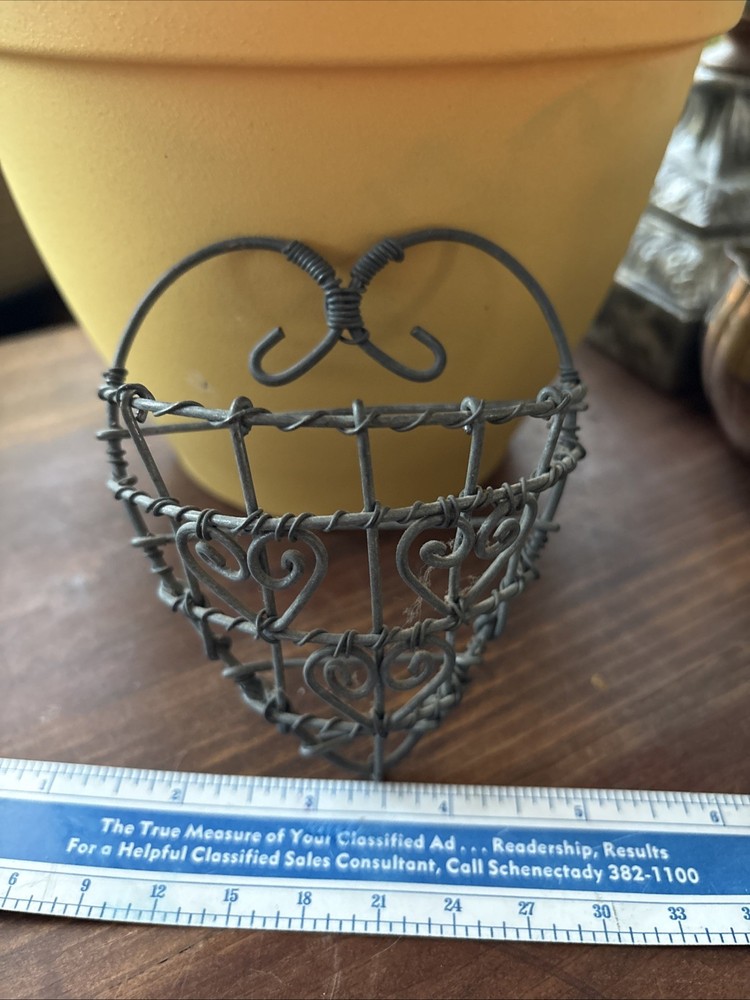rustic, heart-shaped wire basket with scrollwork details.