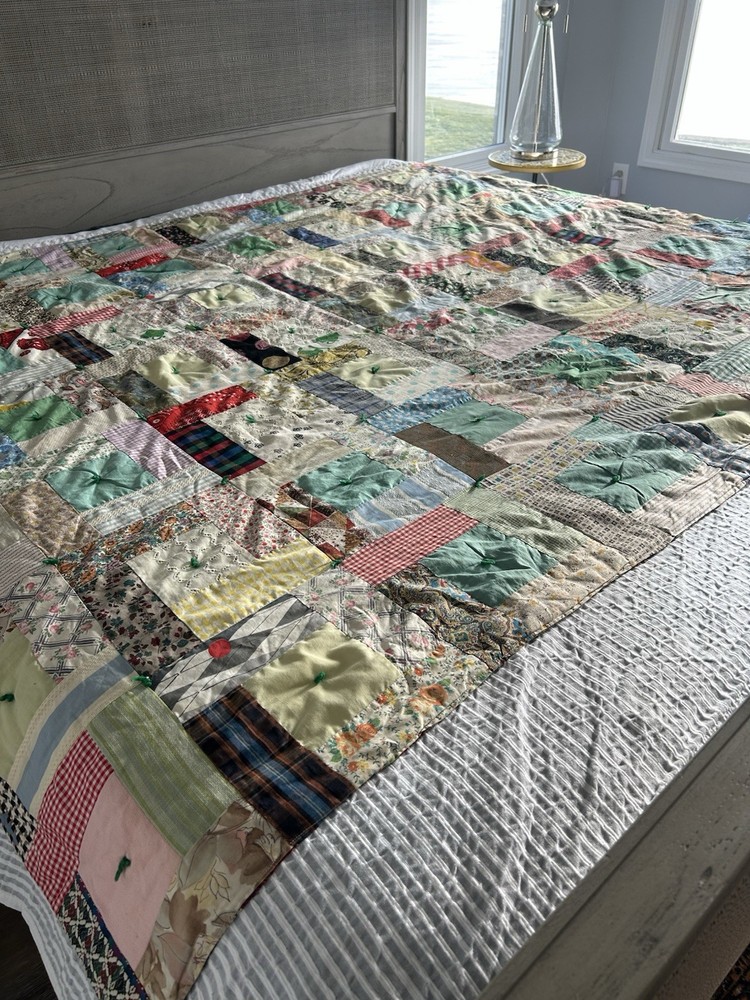Handmade patchwork quilt with mixed fabric patterns