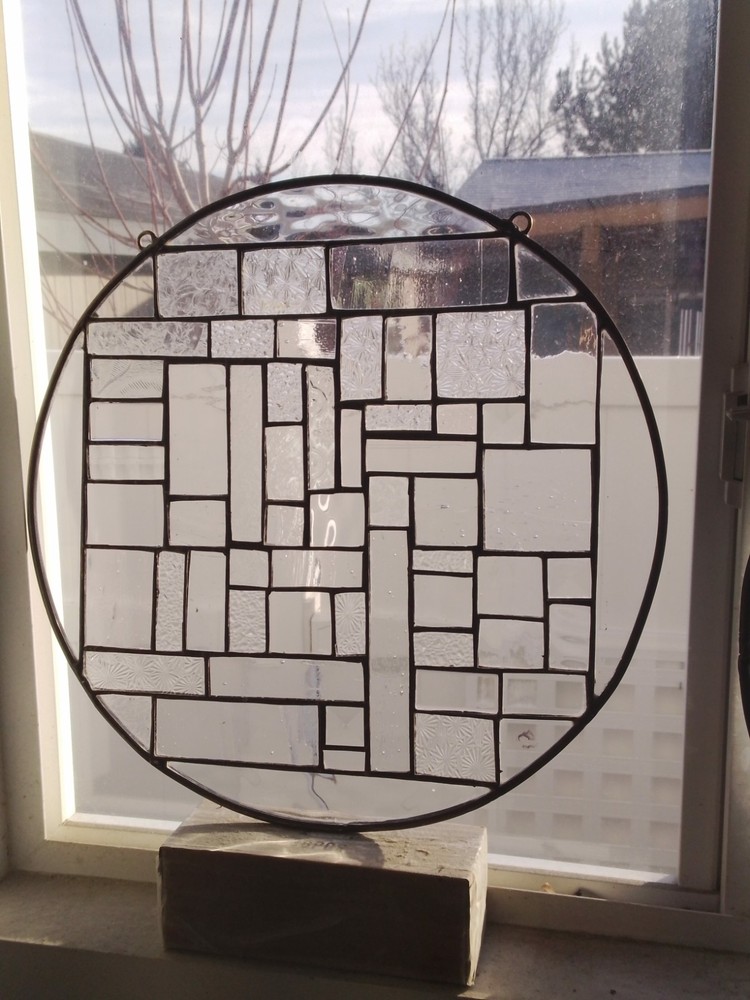 Round stained glass window 14 across abstract  pattern