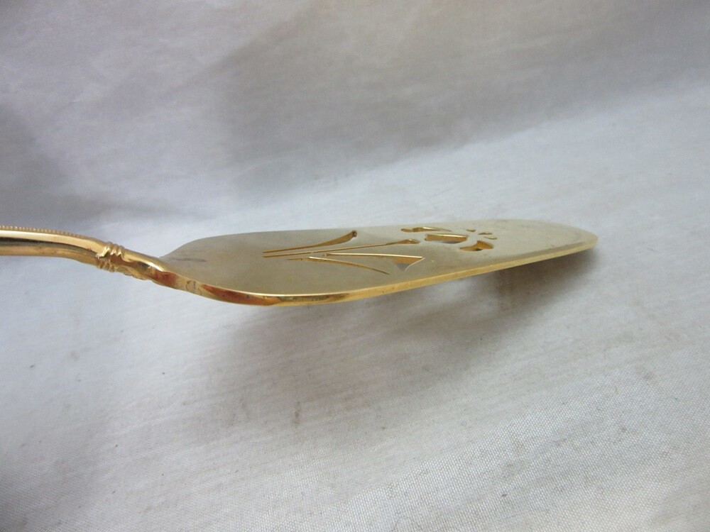 Gold plated cake server with red enamel handle