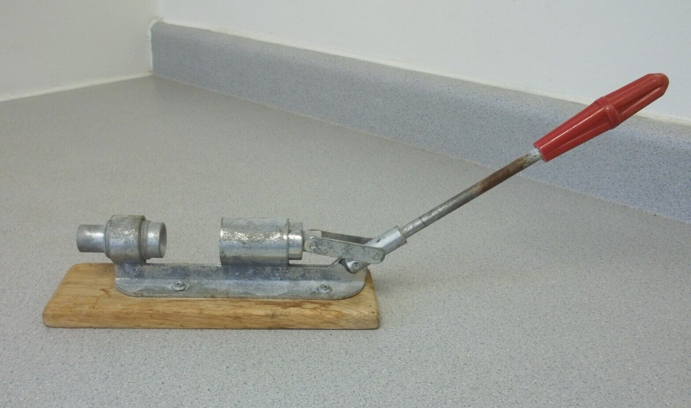 Nutcracker with red handle knob on wooden base Vintage adjustable nutcracker