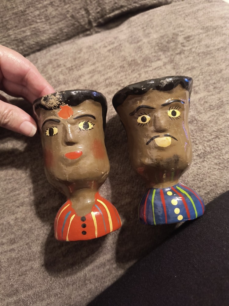 These items are handcrafted ceramic face vases or pots
