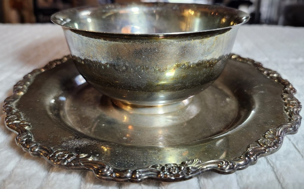 Silver-plated ornate bowl with attached underplate, possibly Oneida or Wallace.