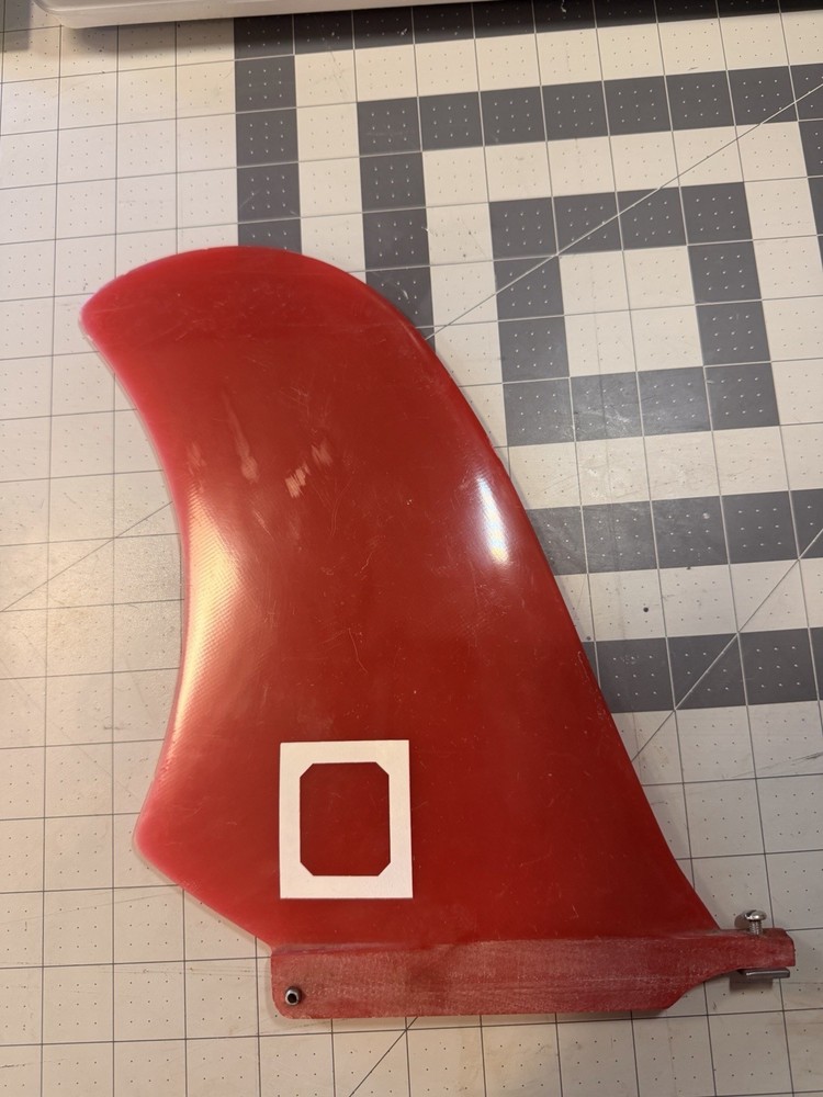 Red Surfboard Fin with Wizard Graphic