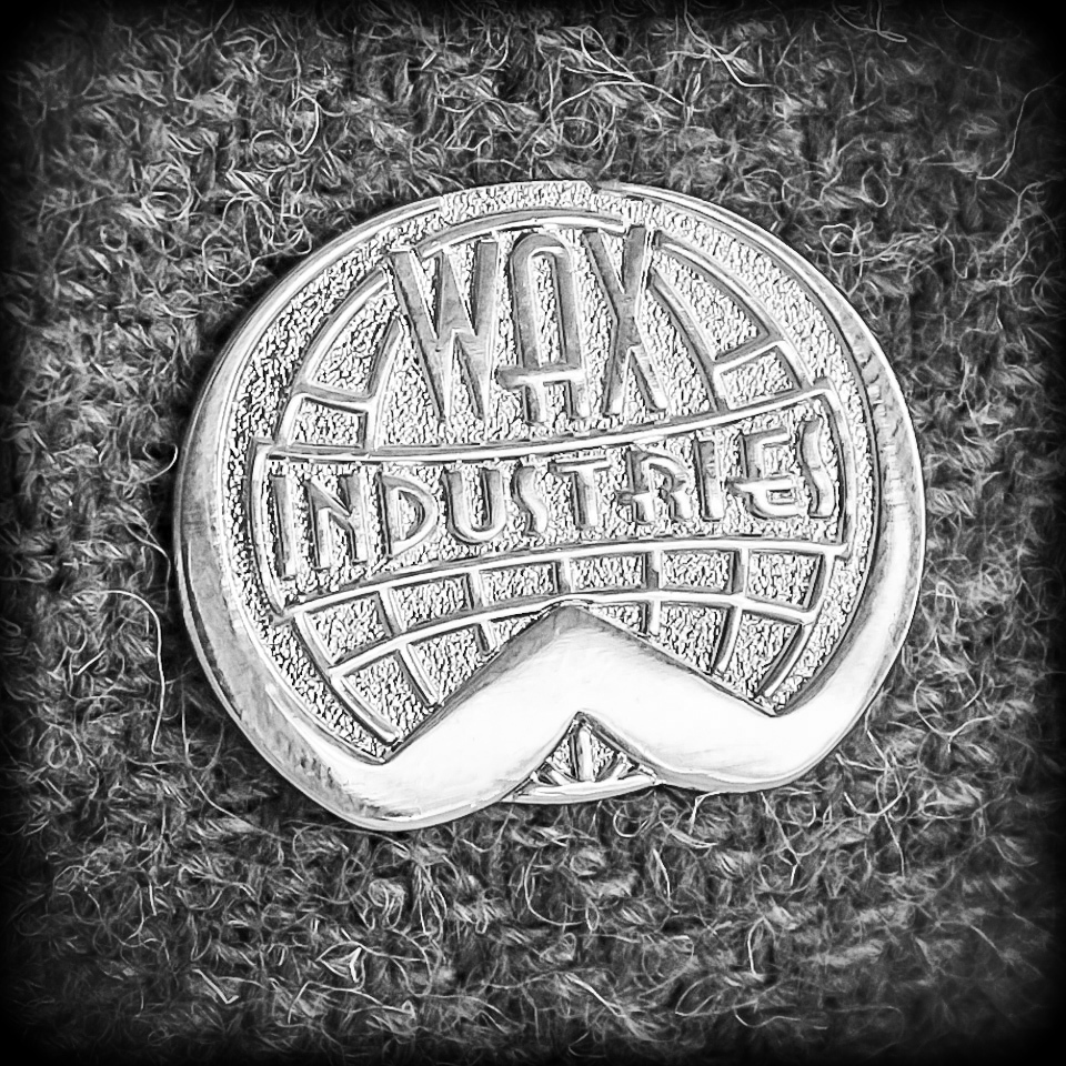 Wax Industries lapel badge