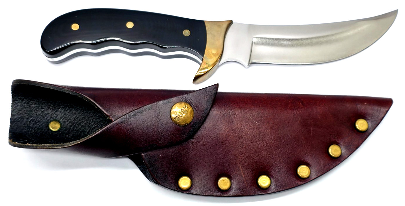 Buck Kalinga knife with black handle and brown leather sheath