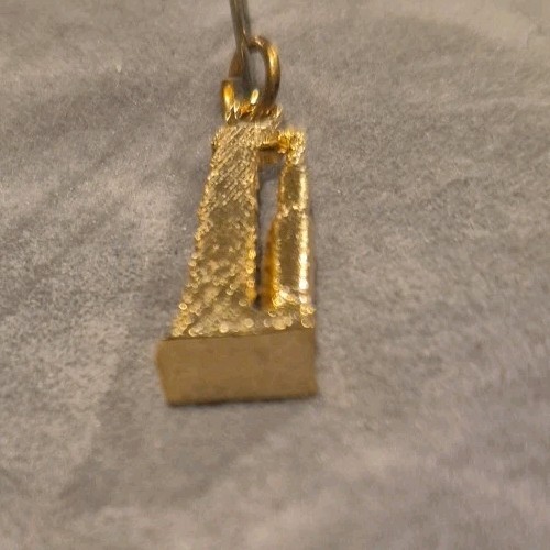 Vintage gold-tone Space Shuttle launch pad charm