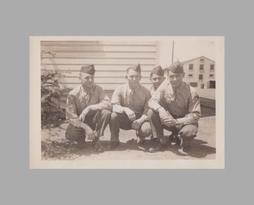 WW2 Photo U.S. GIs Squatting By Base Building