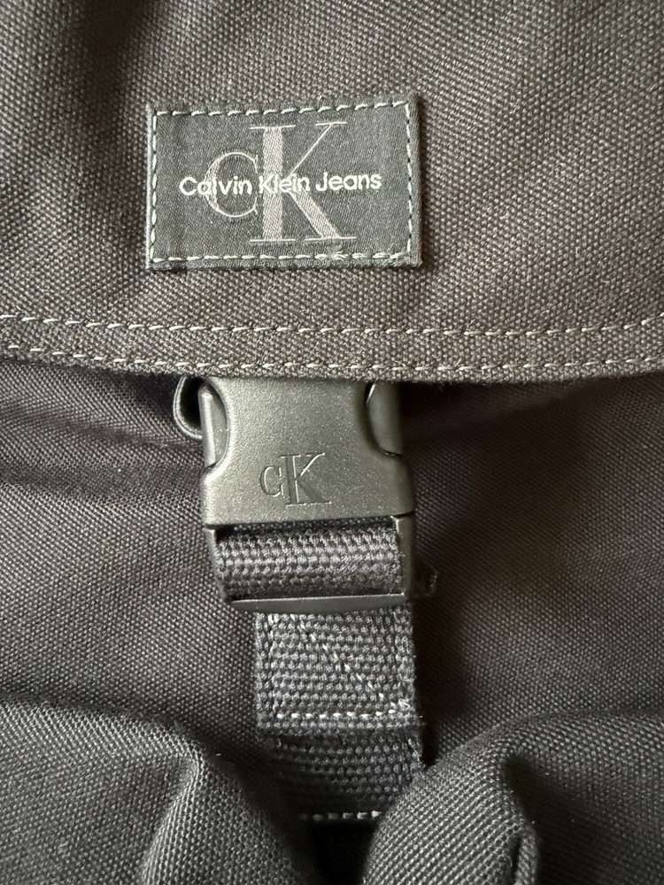Calvin Klein Jeans Black Backpack Drawstring Flap Top Front Pocket Bag NWT