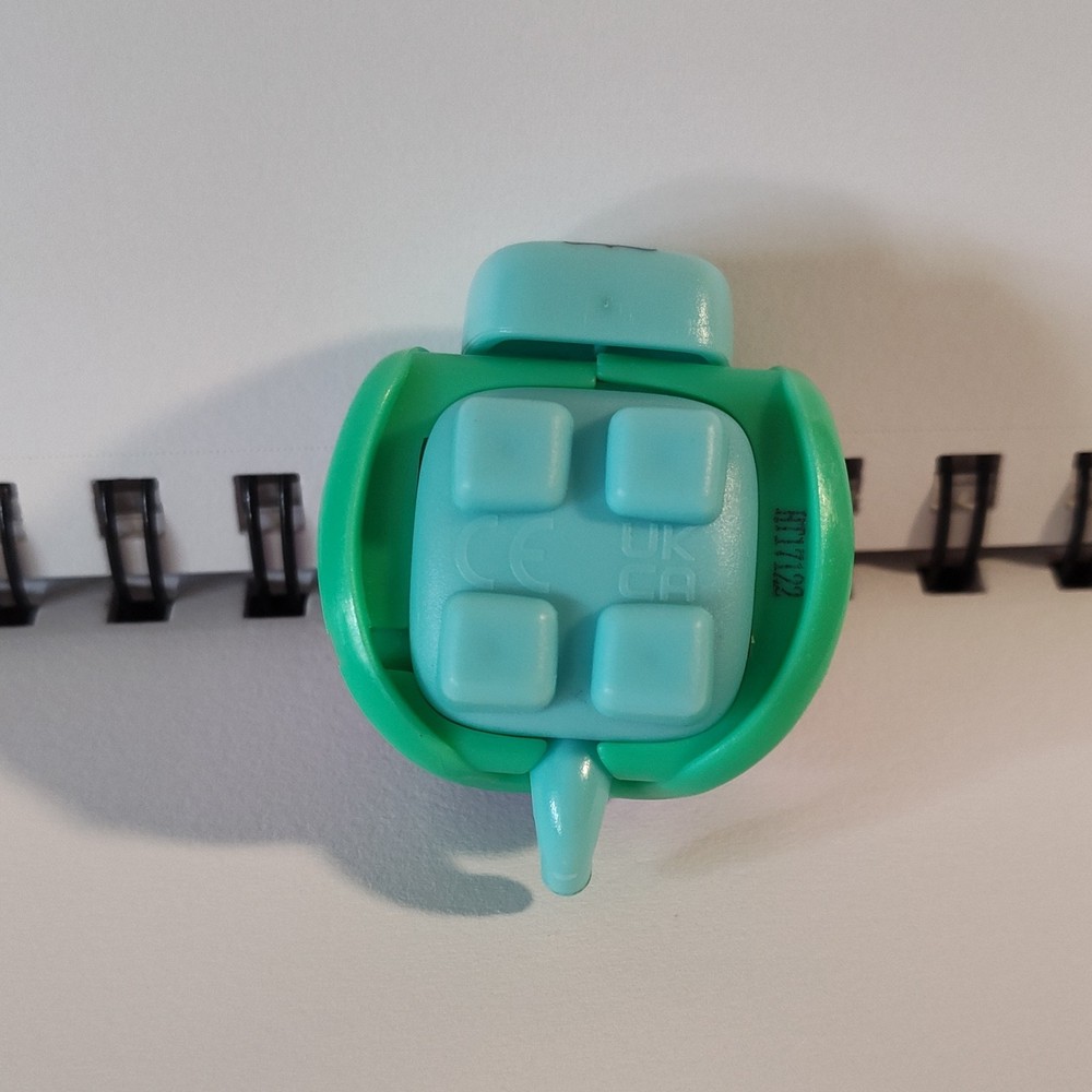 Squirkies purple and green fidget turtle toy.