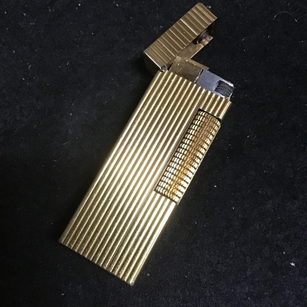 Overhauled gold dunhill lighter with striped pattern, ignition functioning well