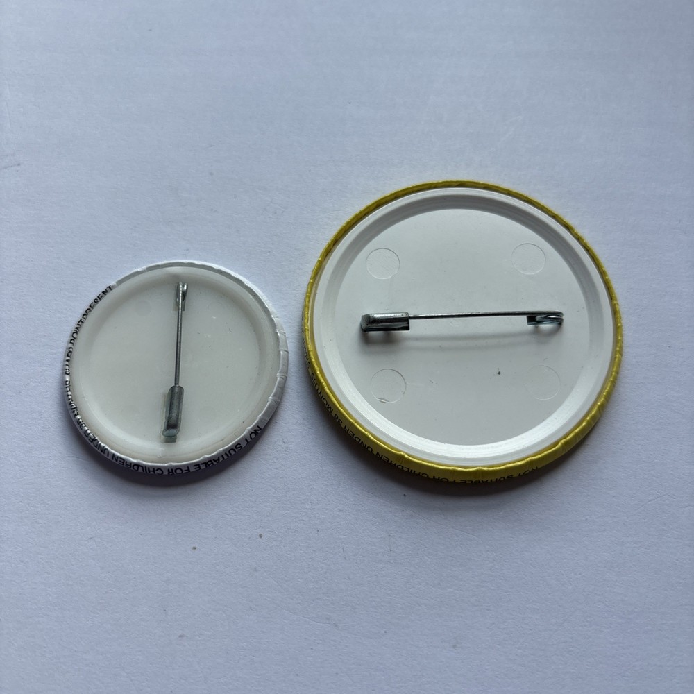 Two University Pin Badges.