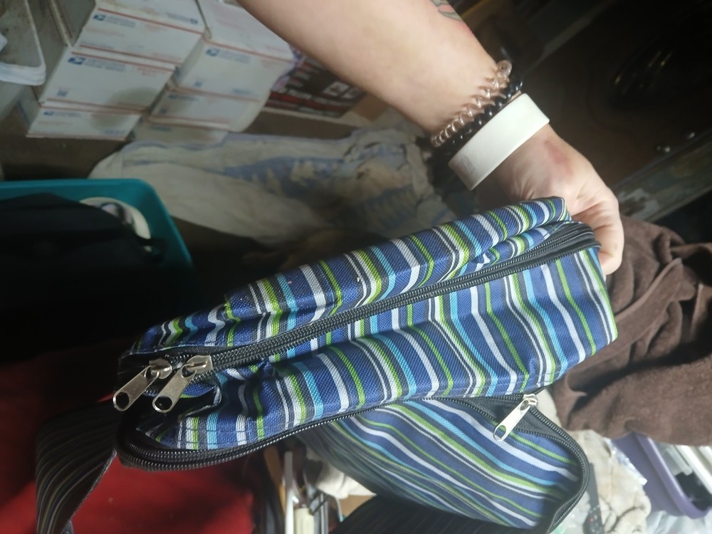 blue striped insulated bag with a reflective interior lining,