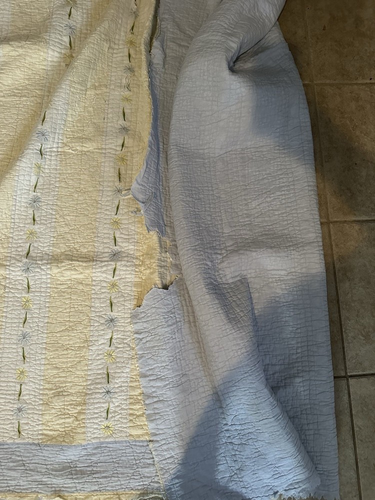 Cutters Handmade quilted bedspread with striped pattern and floral embroidery.