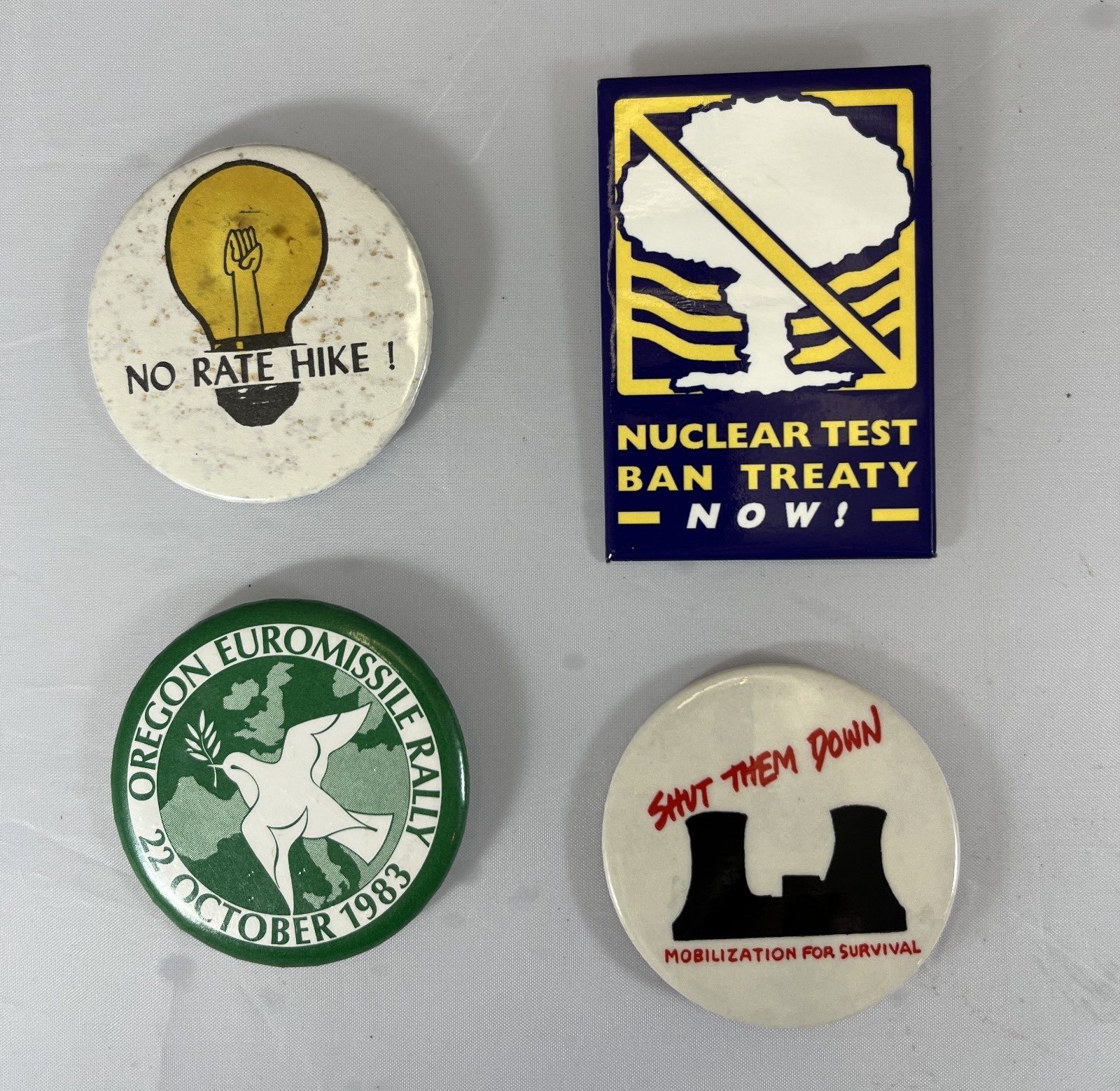 LOT OF 4 PINBACKS BUTTONS ANTI-NUCLEAR UTILITY RATES EUROMISSILE TEST BAN TREATY