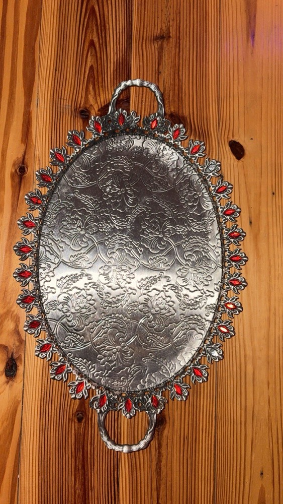 Thin silver tray with red jewels
