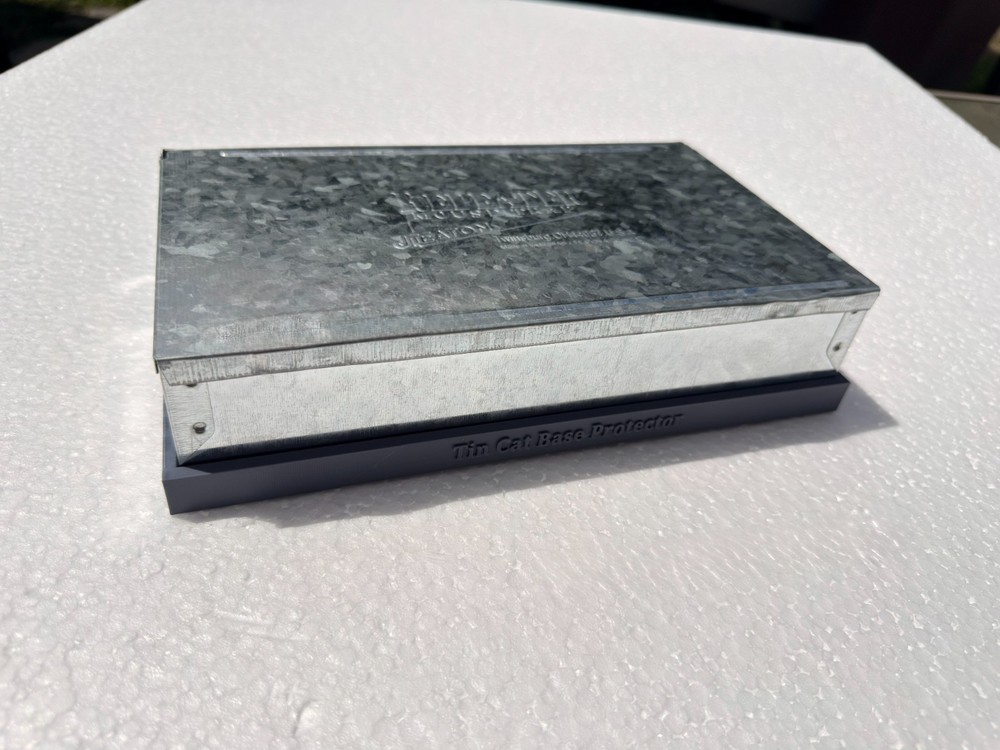 Tin cat mouse trap base protector.