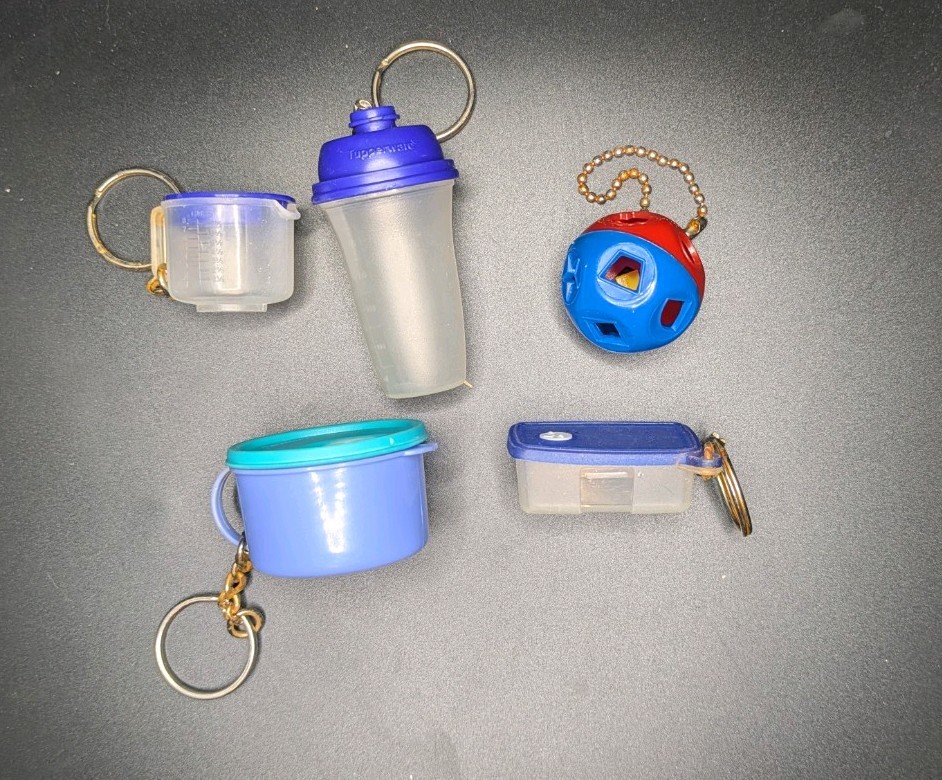 5 miniature Tupperware keychains with removable lids