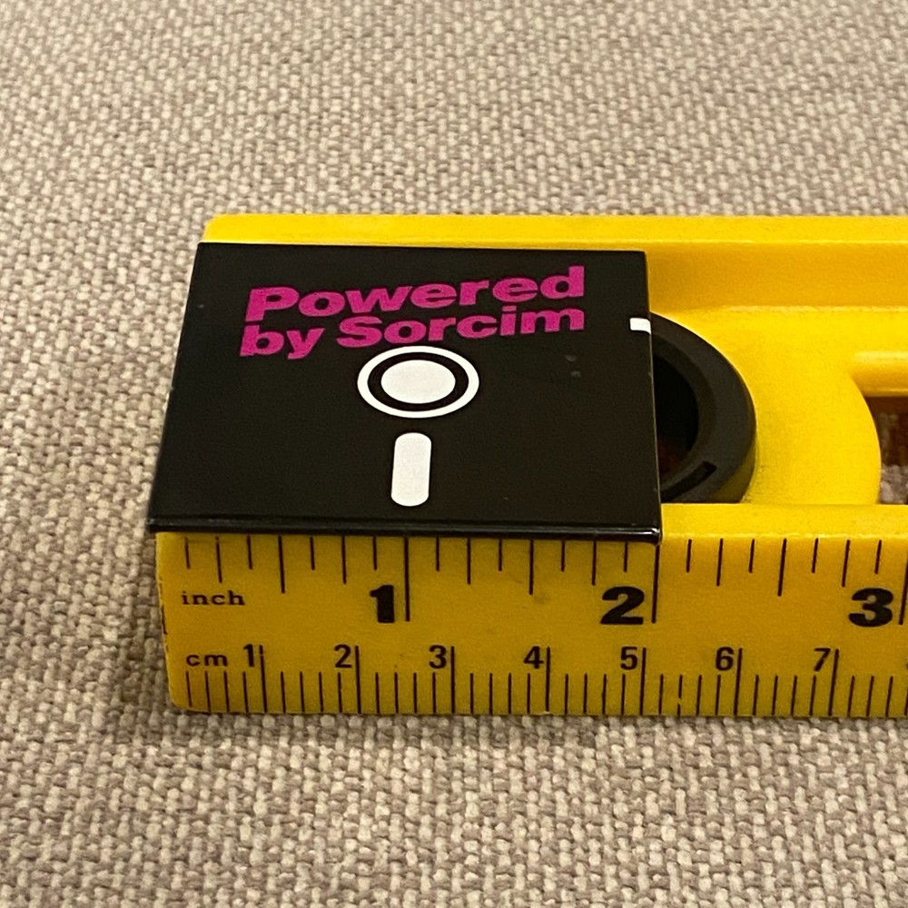 Vintage Powered by Sorcim Pinback Button Floppy Disk Software Tech Advertising