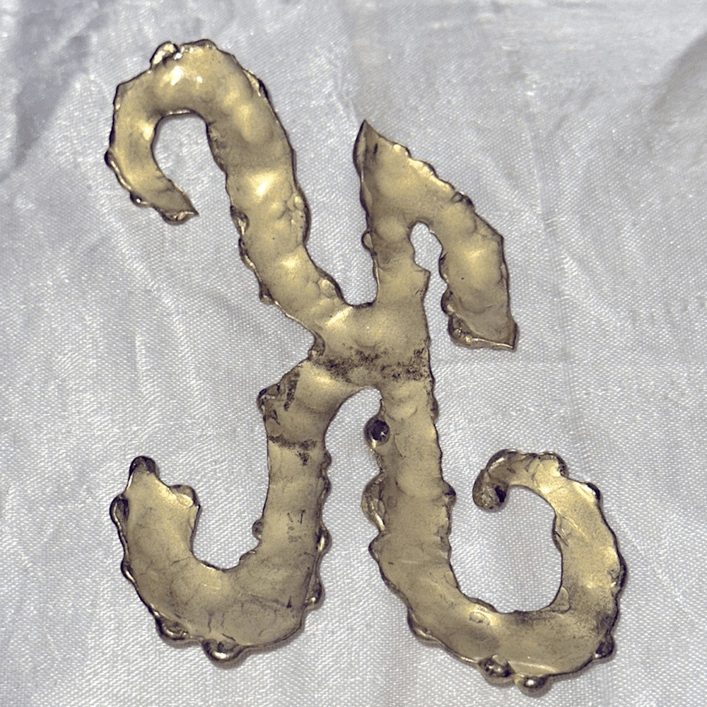 Vintage hammered brass K”