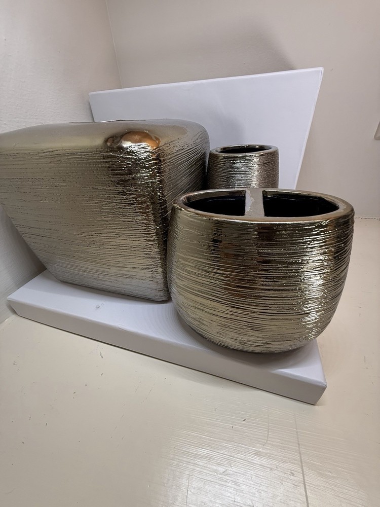 textured metallic home accessory set, possibly including a tissue box cover