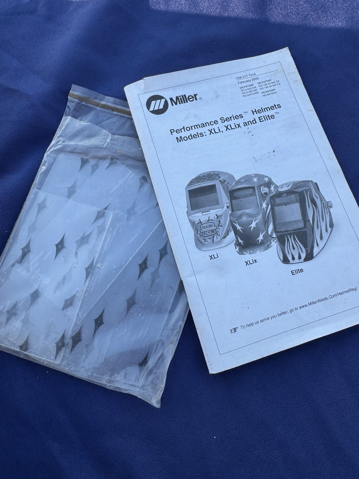 Miller Elite Welding Helmet with manual and extra lenses, new batteries