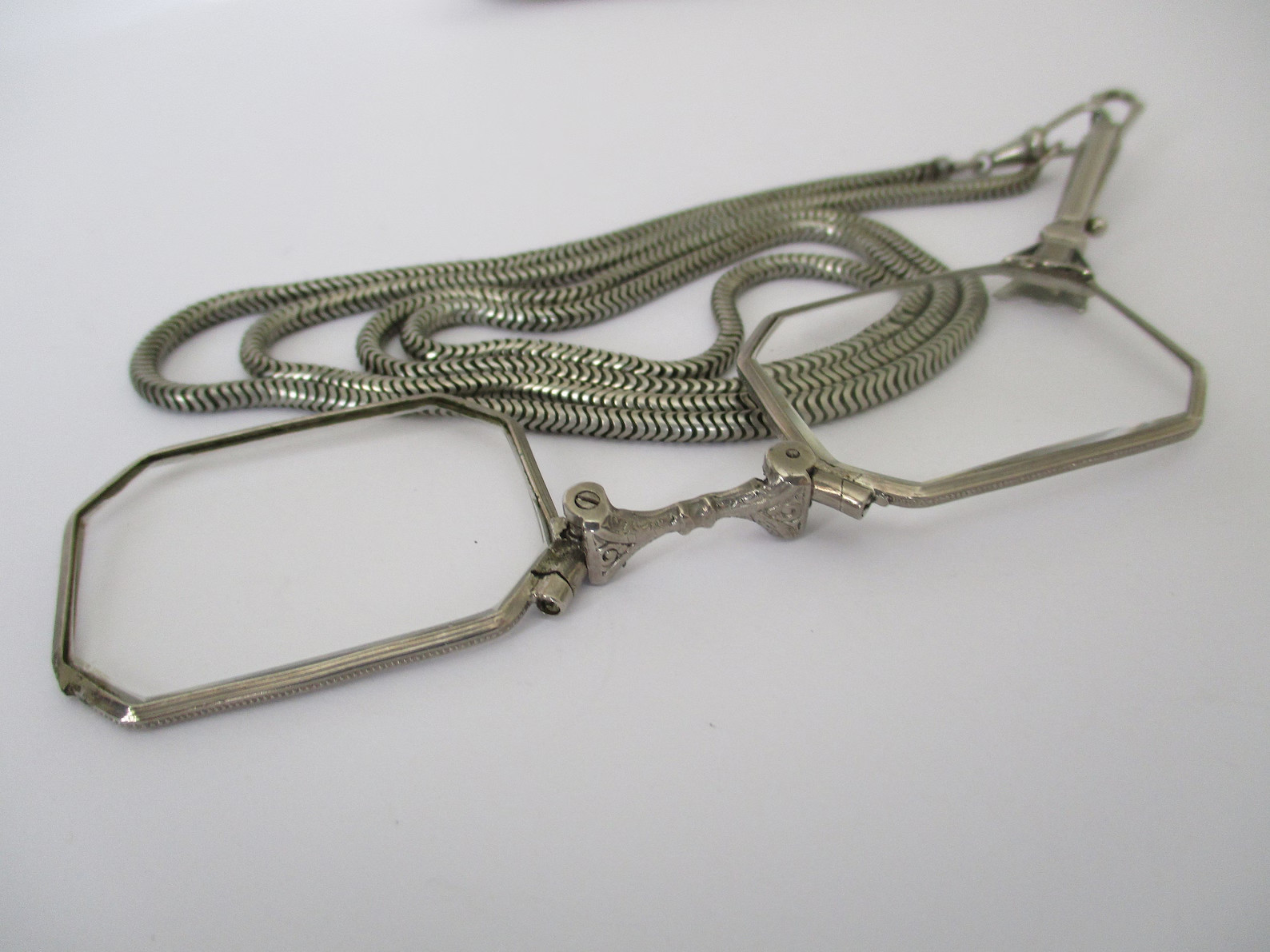 A Deco style lorgnette with guard chain